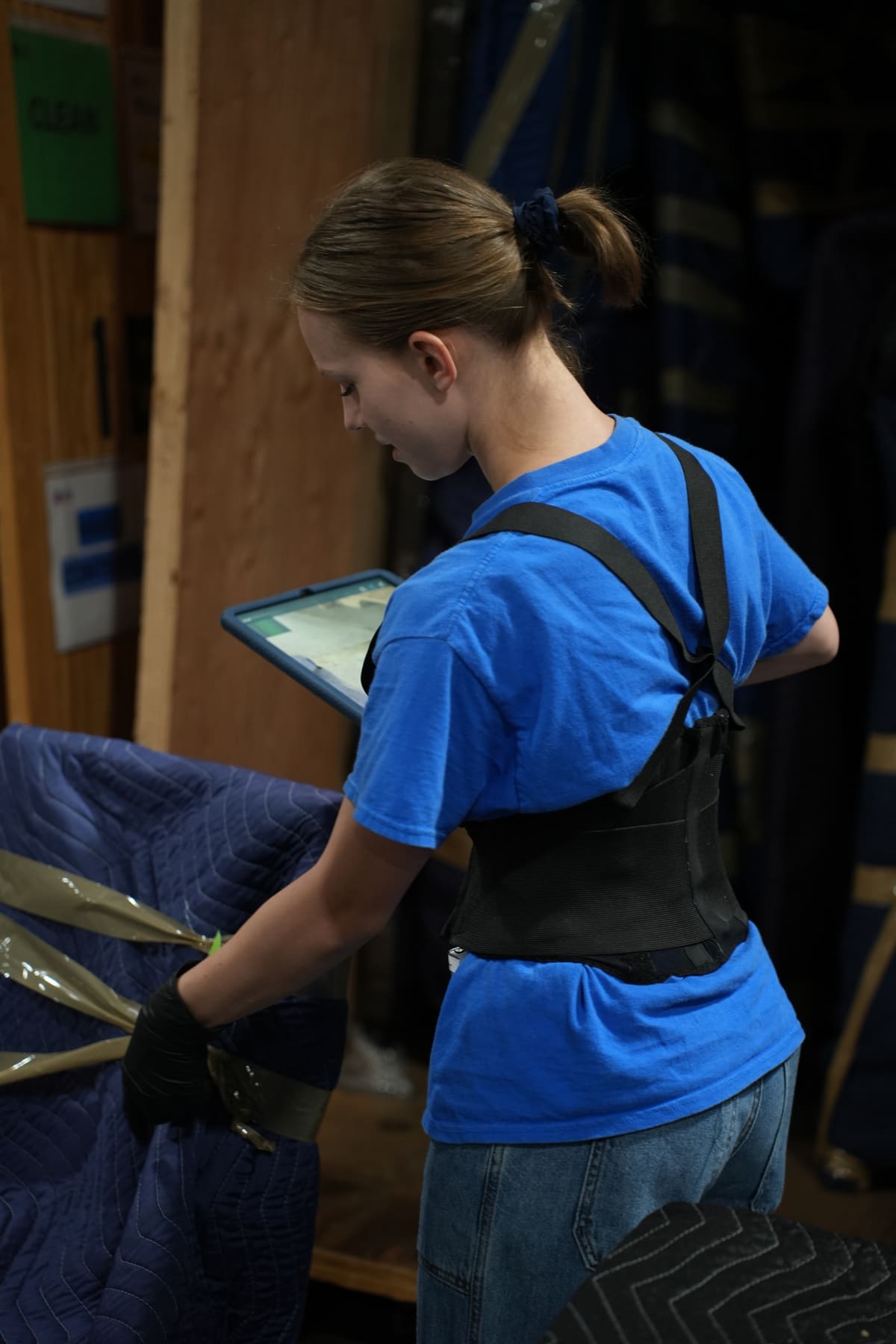 A Superior Contents technician logs a blanket-wrapped item into the tablet inventory