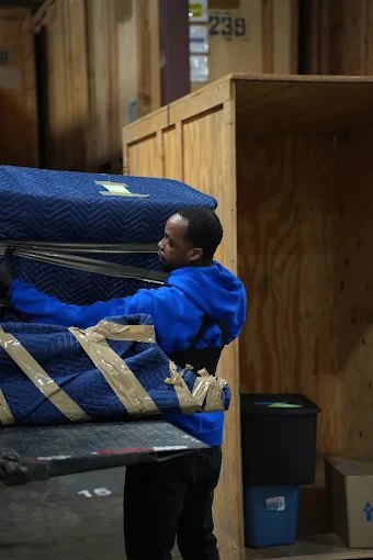 Blanket-wrapped furniture placed into secure storage
